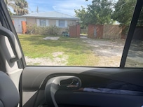 This is wooden gate you go though to get to rental hard to read but address is poorly painted on red fence