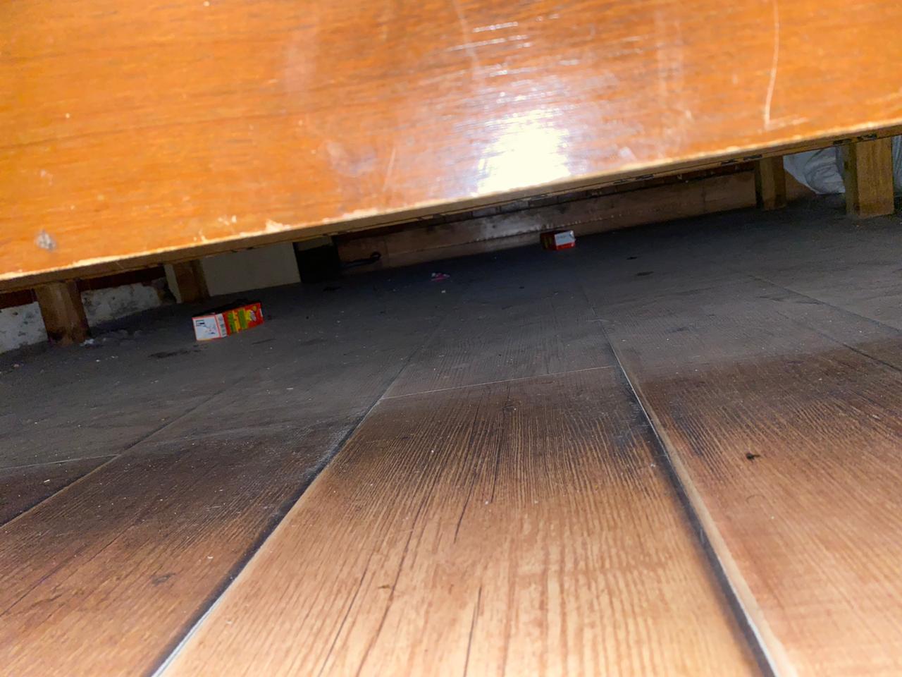 Under the bed.  Note the juice boxes