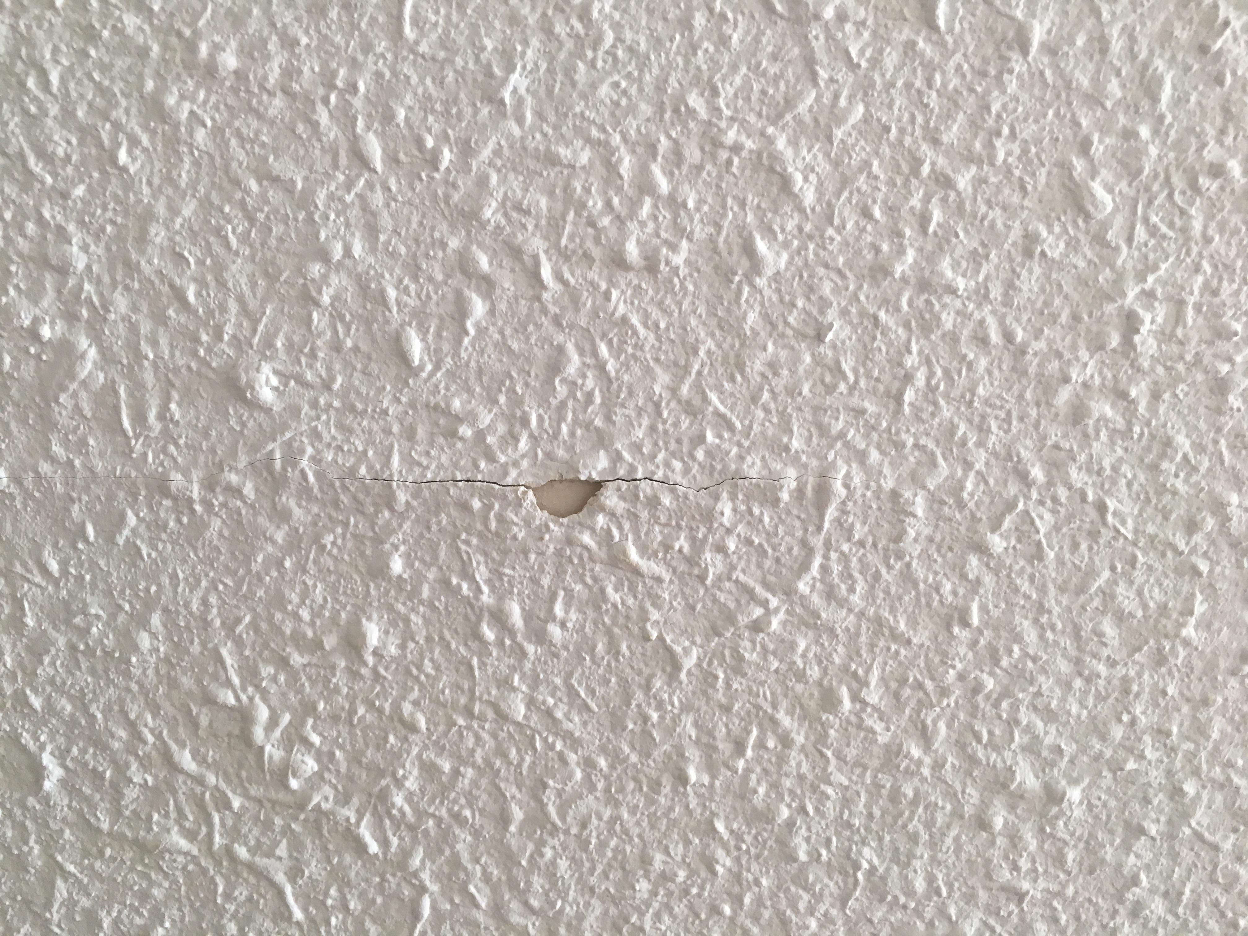 Some damage to wall in bedroom.