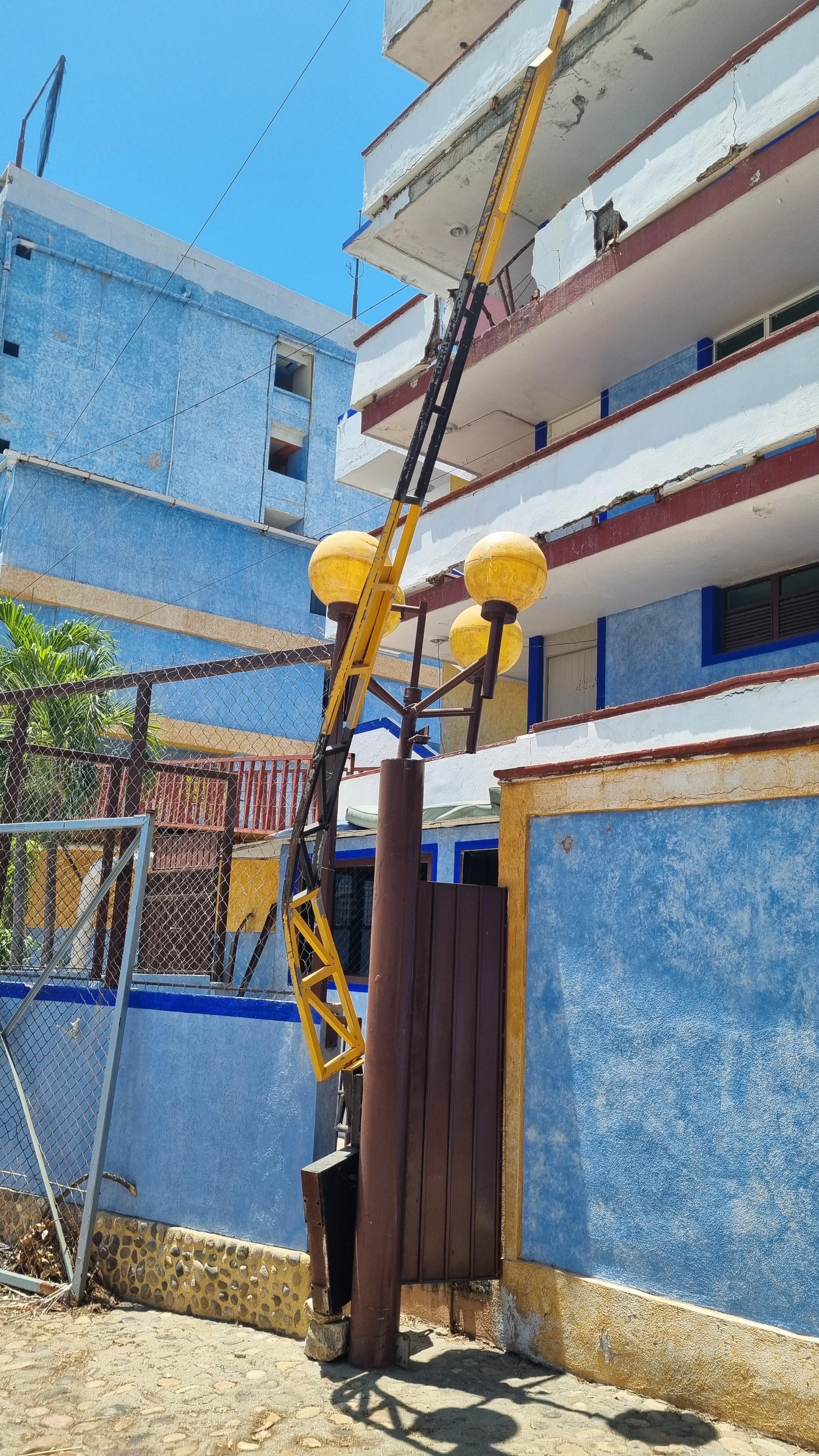 Parking lot security gate. Exterior damage to parts of the hotel. 