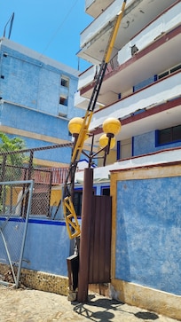 Parking lot security gate. Exterior damage to parts of the hotel.