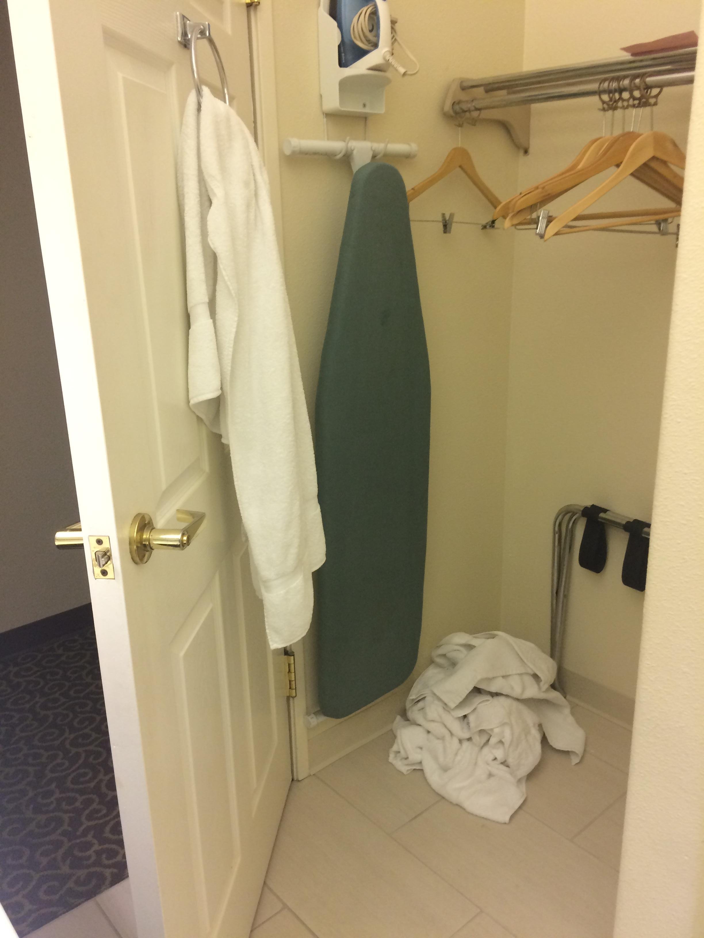 Bare wall with nothing. Toilet paper holder is missing. A couple of shelves or hooks would be nice in this large space.