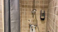 Tiny shower about 1 square foot and a half.
