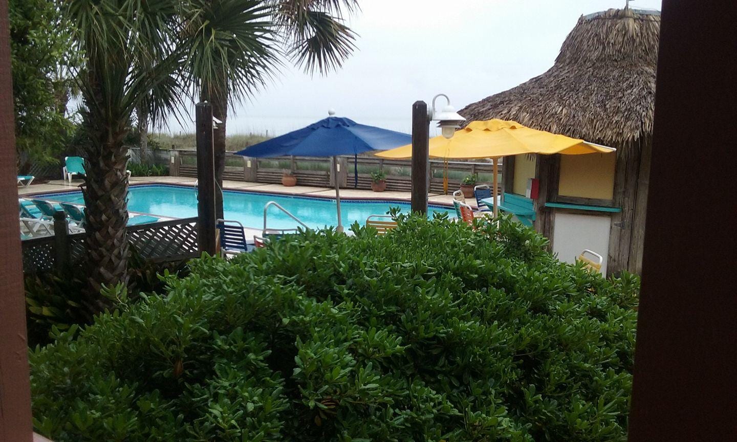 view from our deck, pool and tiki bar