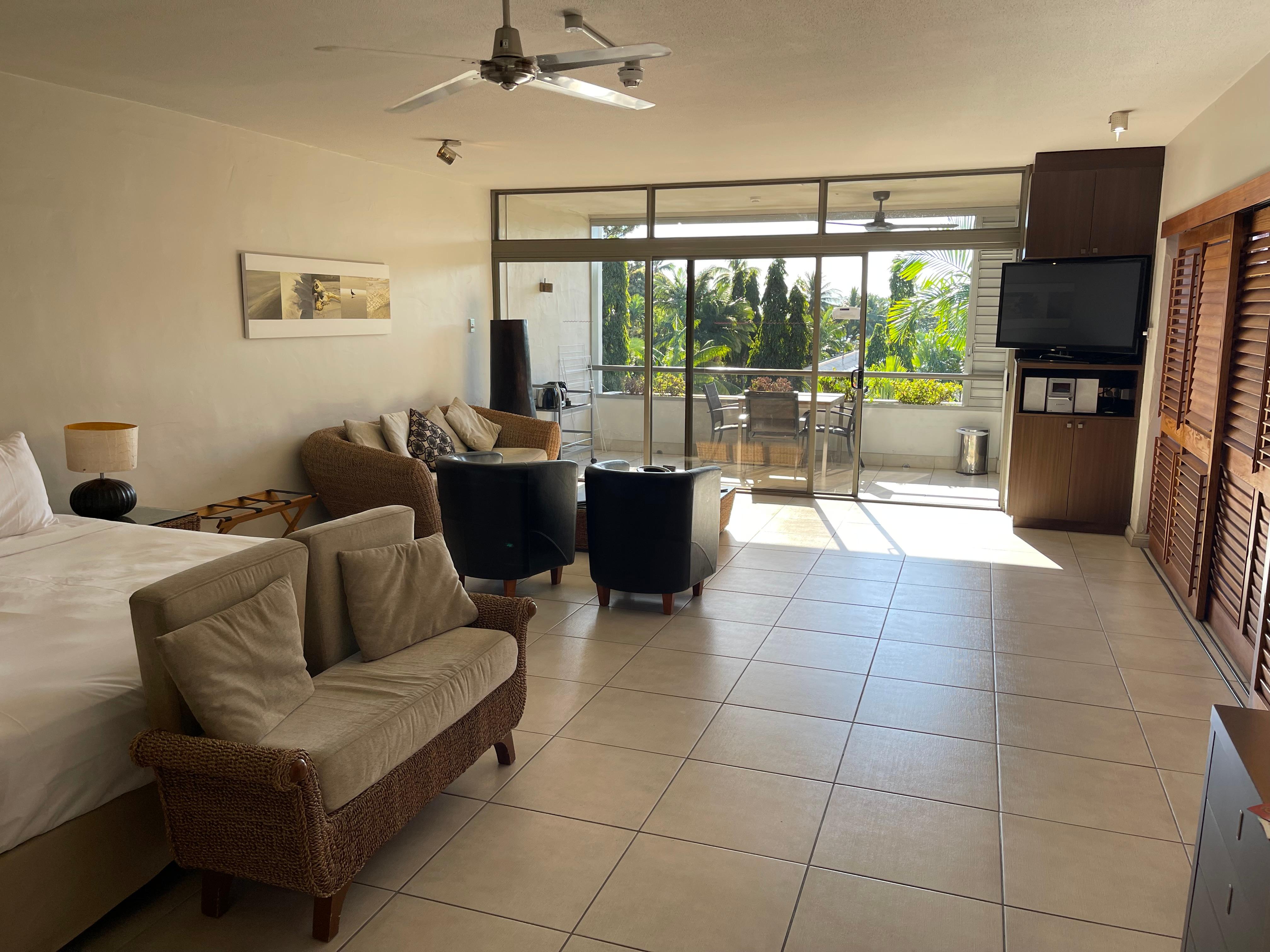 View over bed, lounge and to balcony/kitchenette