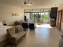 View over bed, lounge and to balcony/kitchenette