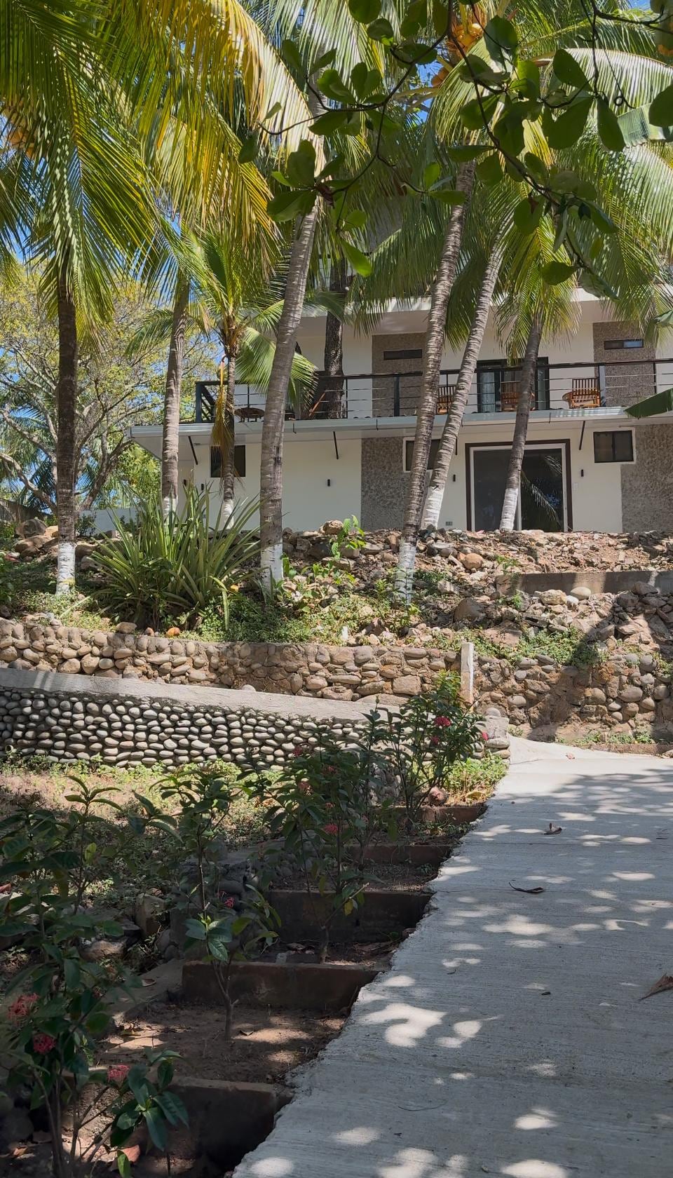 POV from steep walkway to the accommodations from restaurant/ pool area