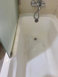 Stained bath and unclean fittings