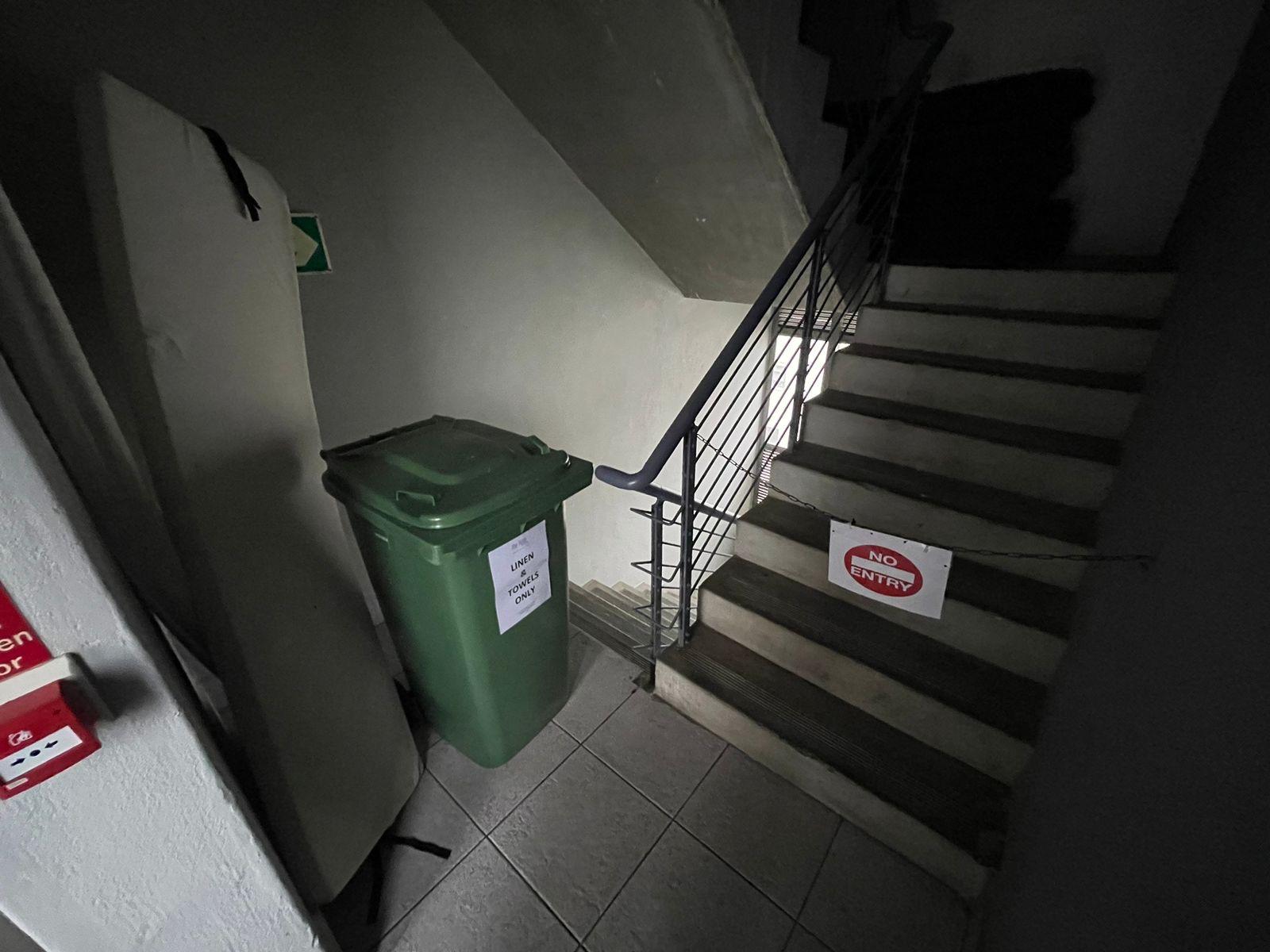 Bin and cushion blocking stairwell