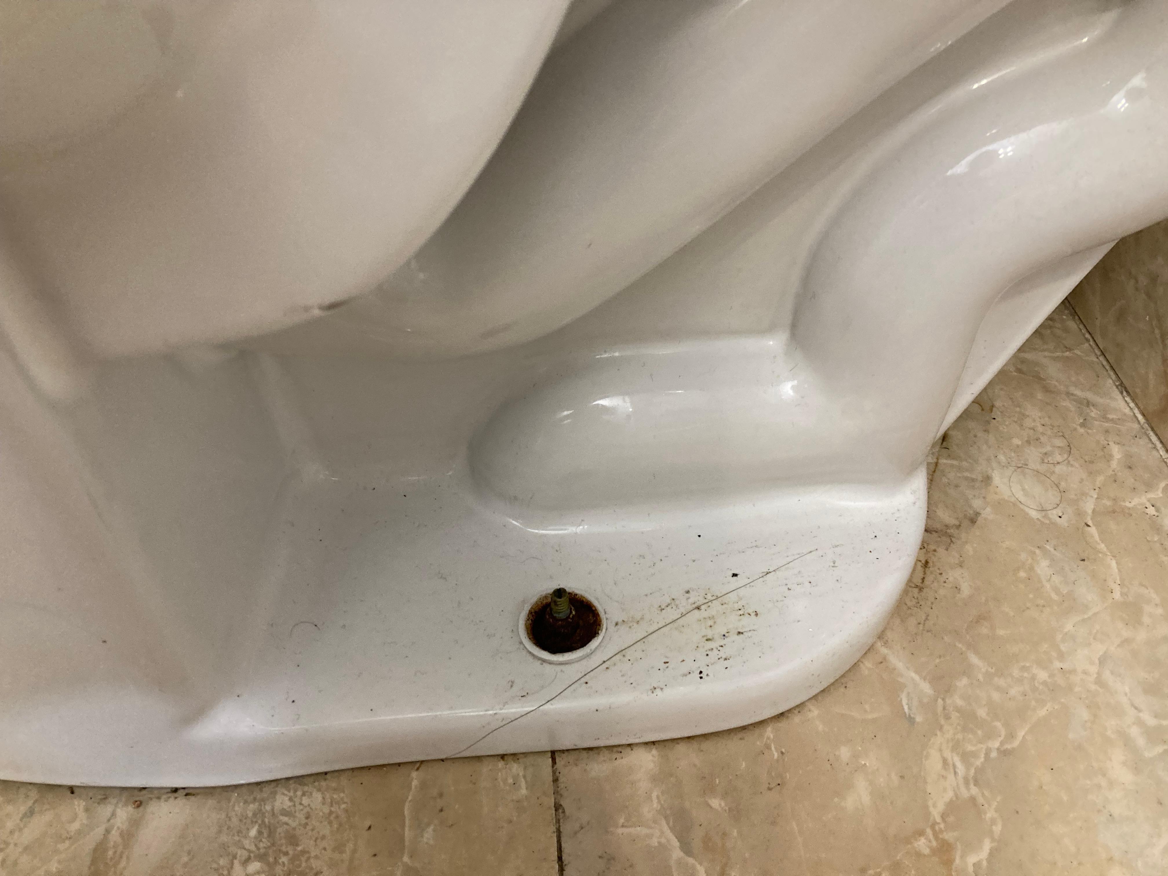 Bottom of toilet, screw is loose