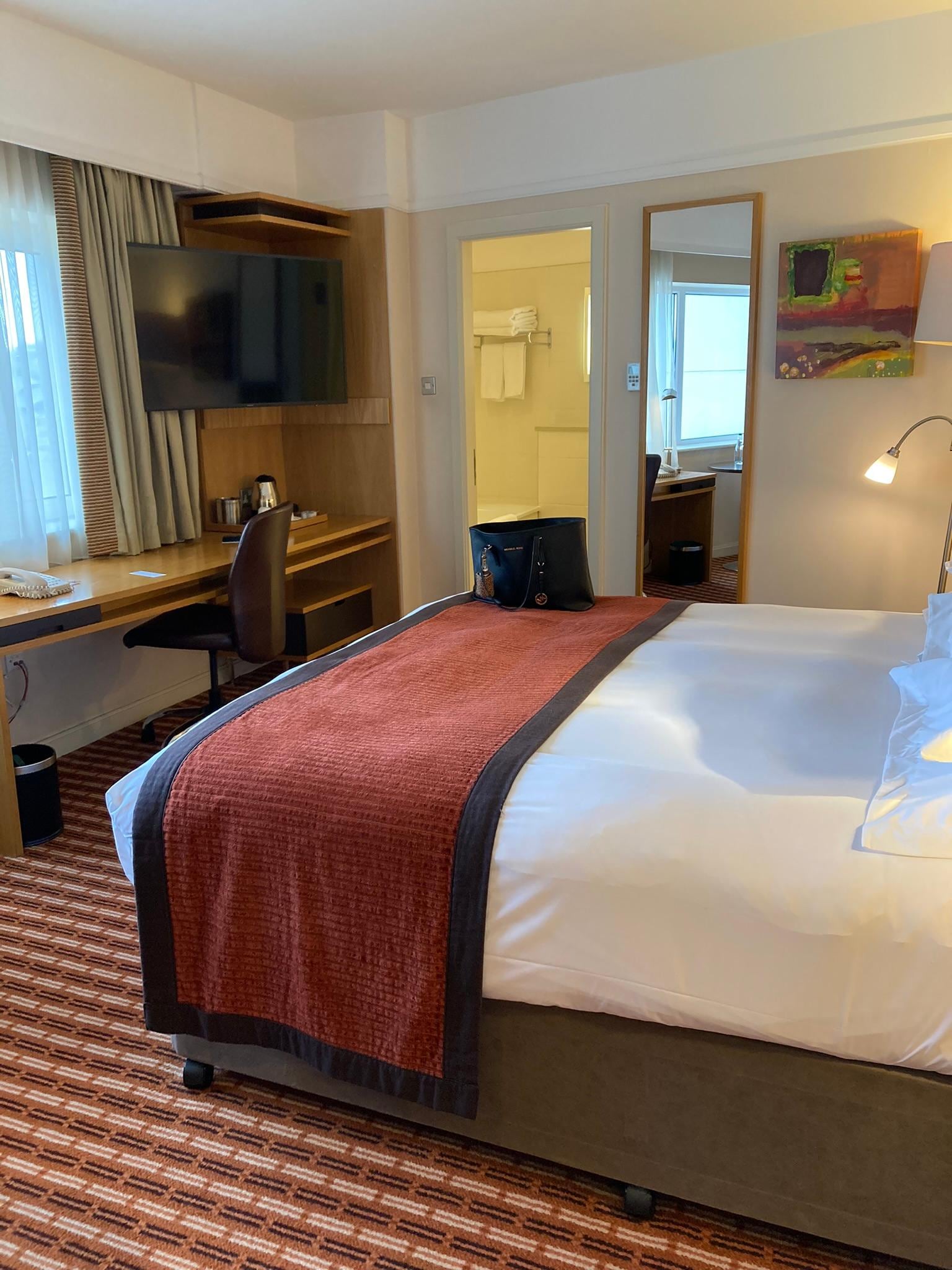 Big comfortable bedroom with safe, fridge, ironing board and trouser press.