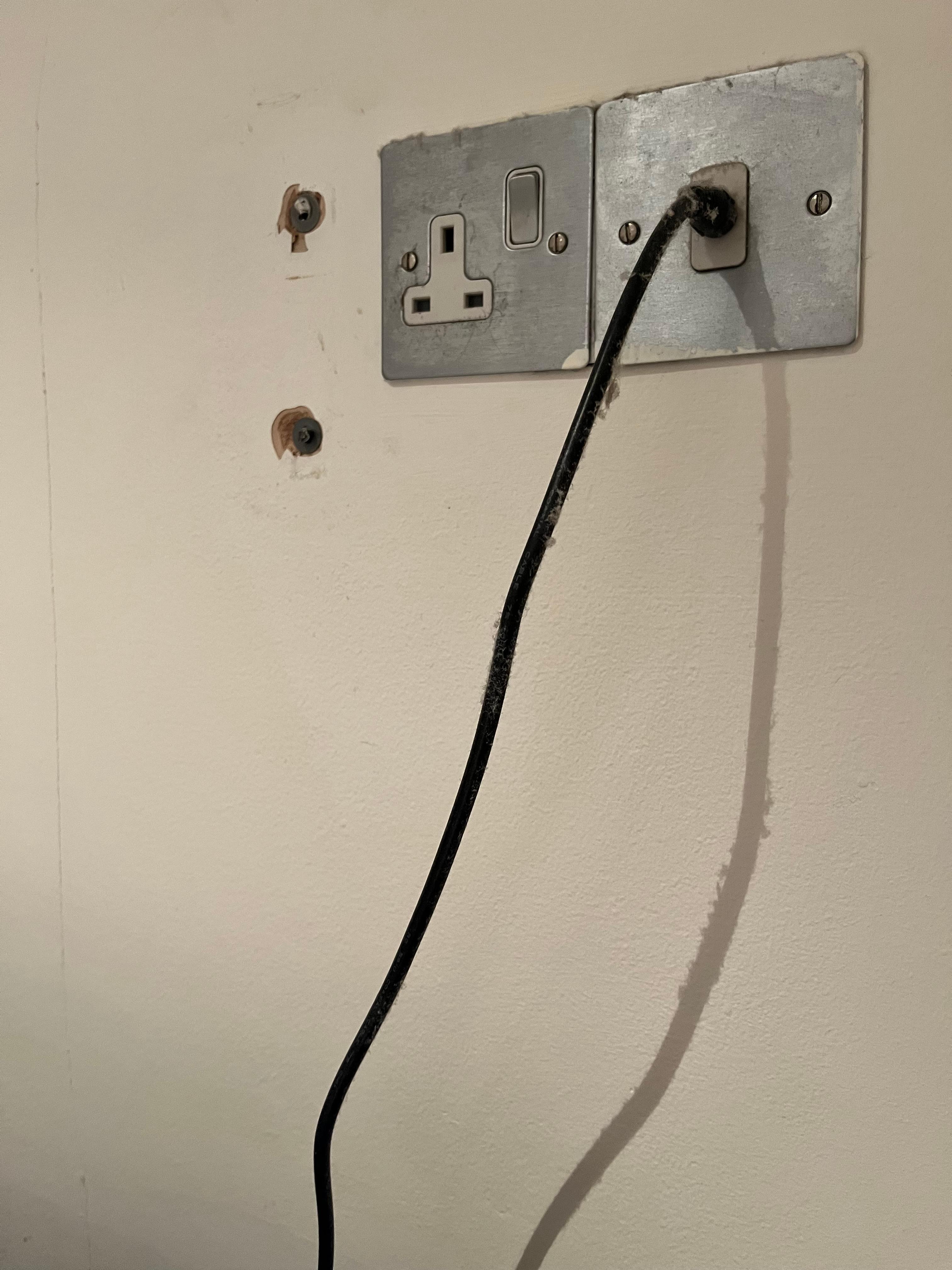 Dust on TV cable and holes in wall from old TV bracket?