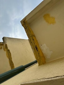 BROKEN OFF COCRETE PIECES OF STRUCTURE UNDERNEATH OF BALCONY ABOVE OUR ROOM!