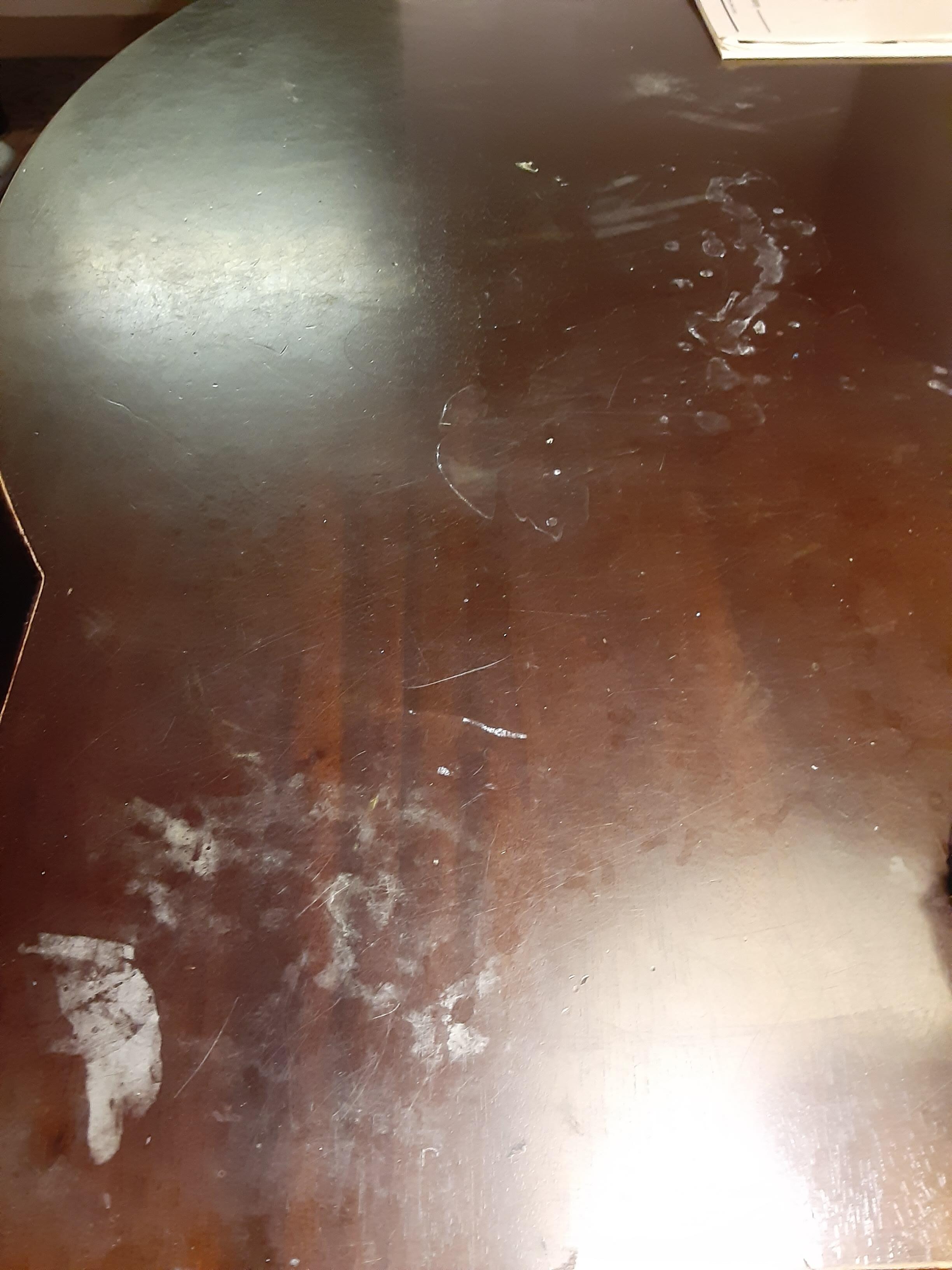 Table in the room badly stained with unknown substance.