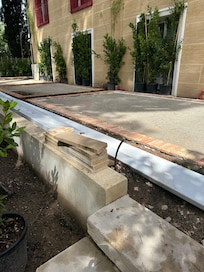 Cutting tile with a tile saw outside of our window.