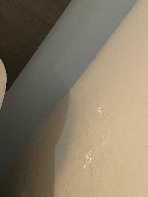 Wall next to bed damaged