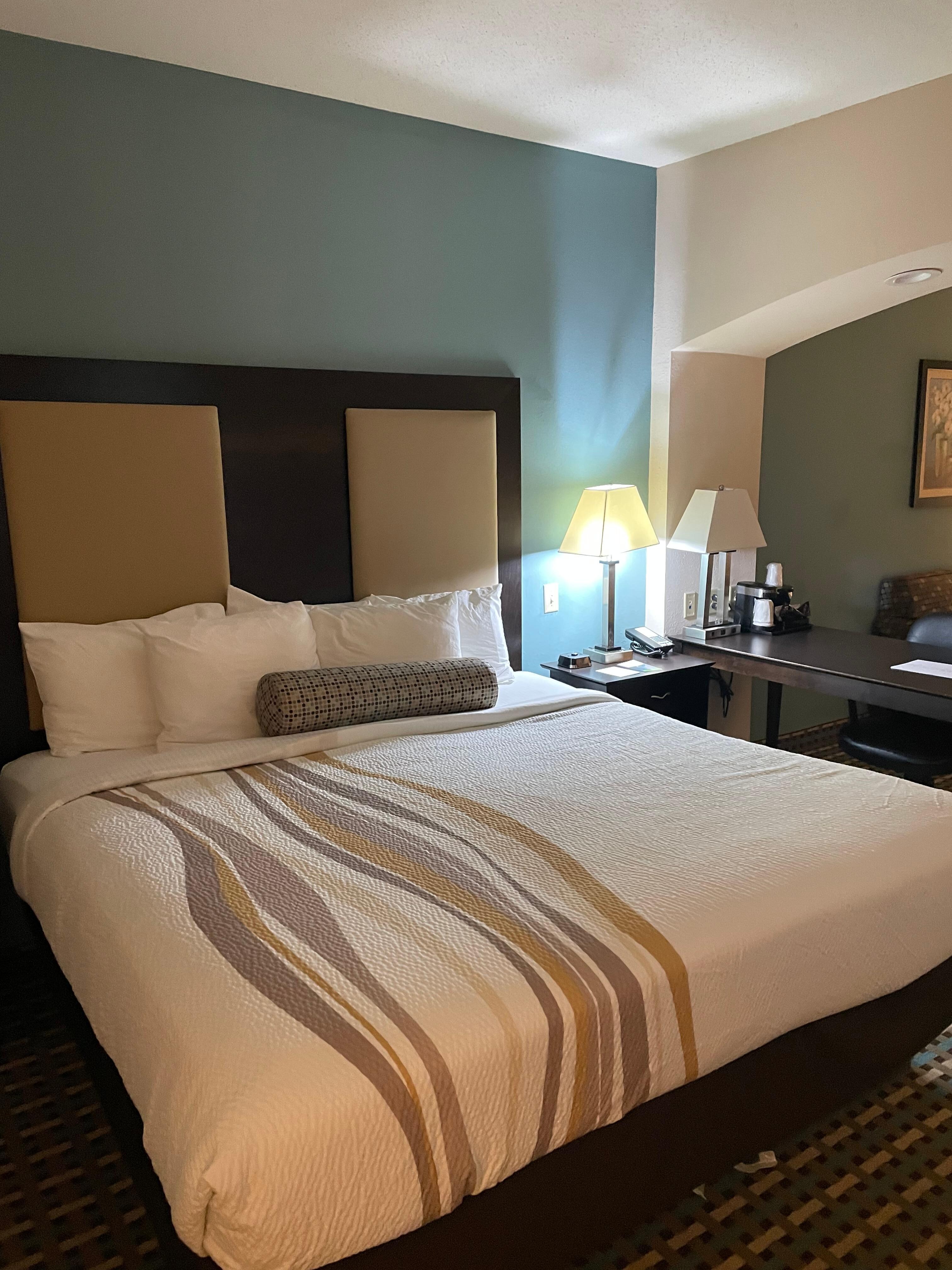 Very comfortable queen size bed with a large assortment of pillows.
