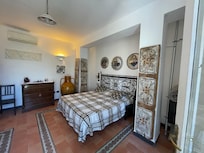 Inside the apartment. Around the corner is a stove and refrigerator, and a bathroom