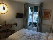 Room #203 - full/queen bed and a small desk.