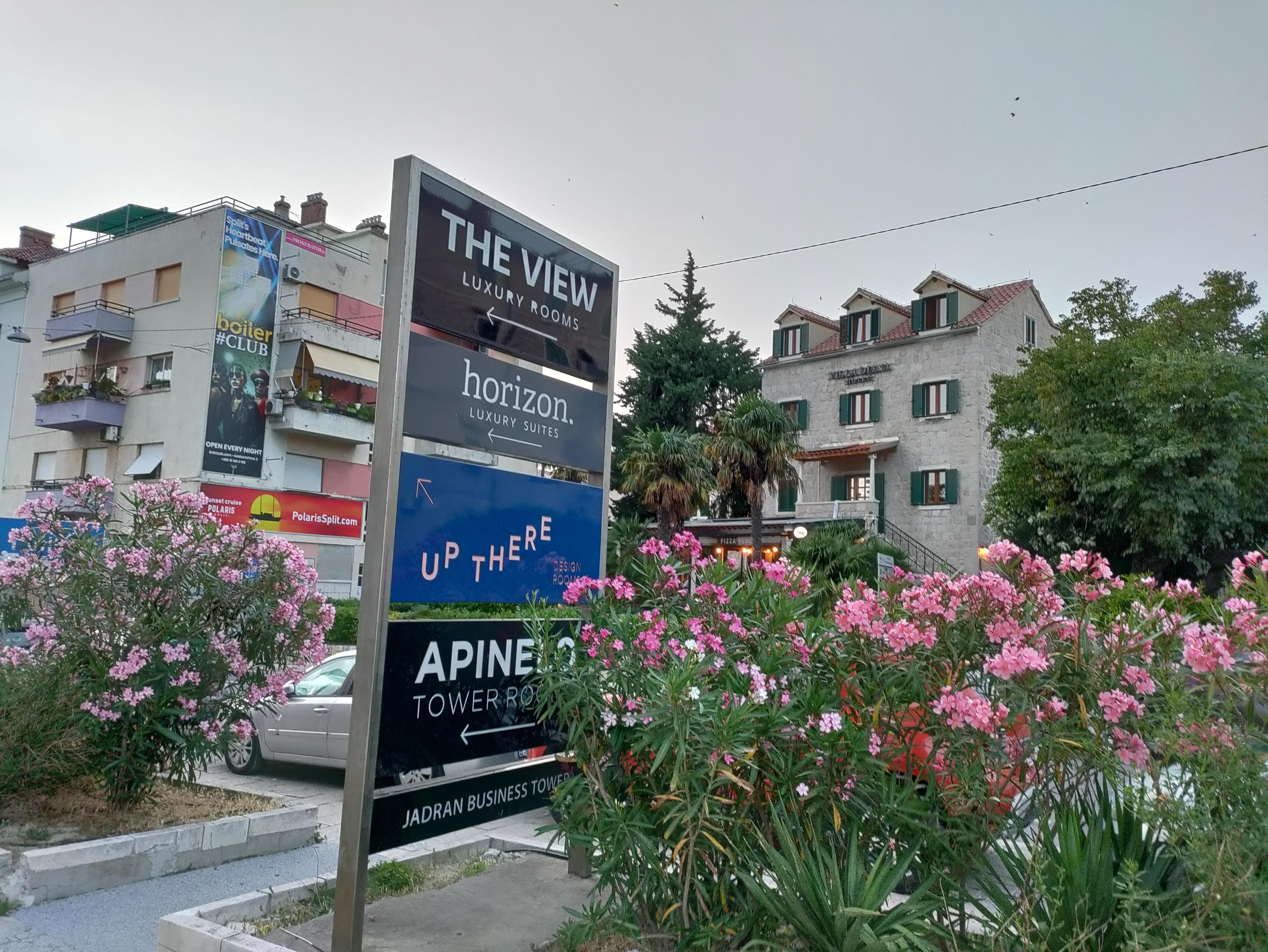 Sign by the street for the hotel.