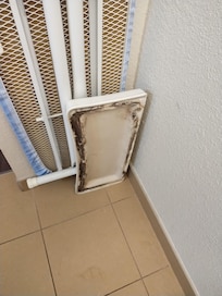 Toilet tank cover leaning against the iron board