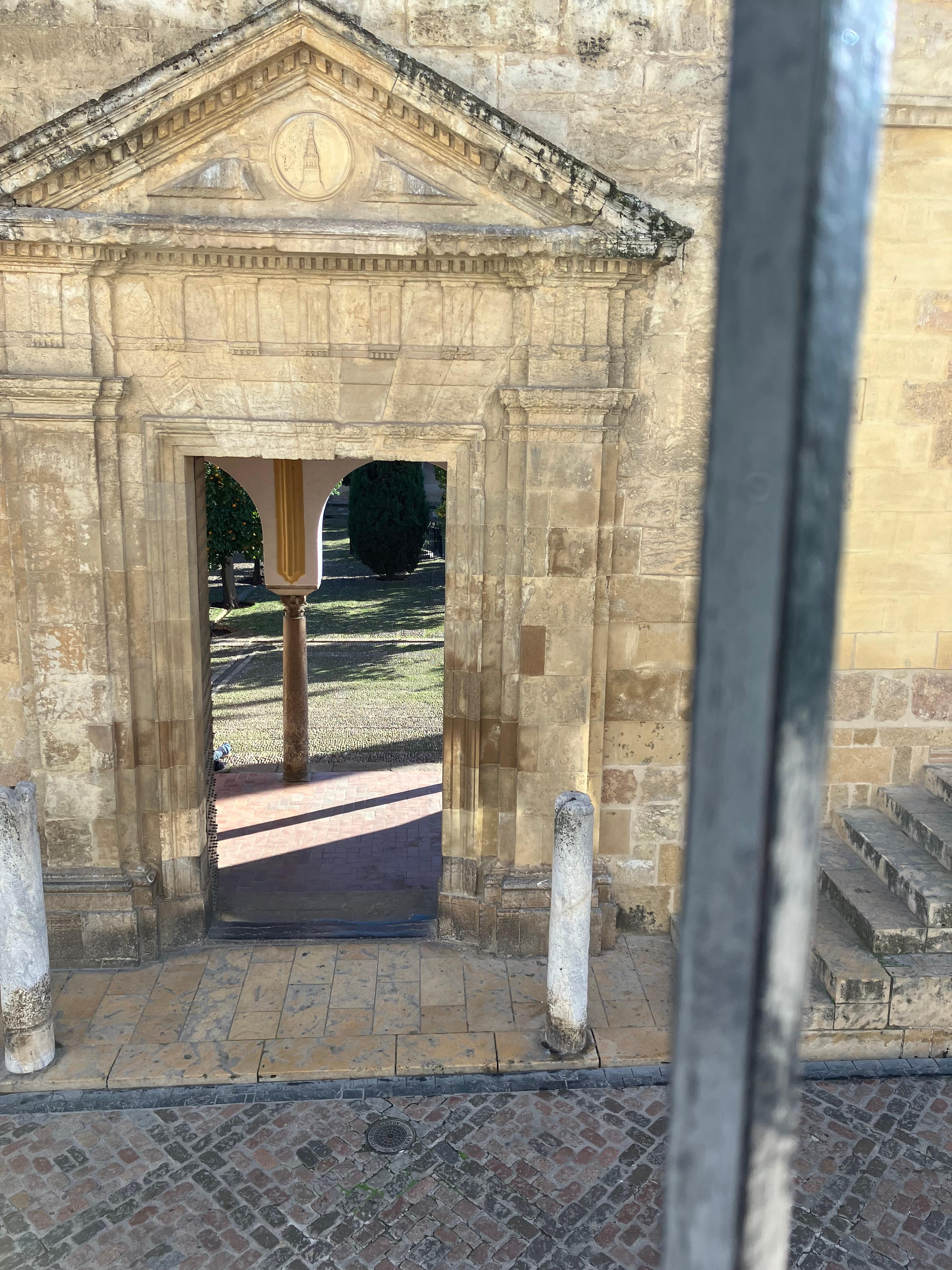 View from room, looking into orange patio of mosque 