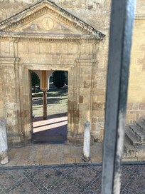 View from room, looking into orange patio of mosque
