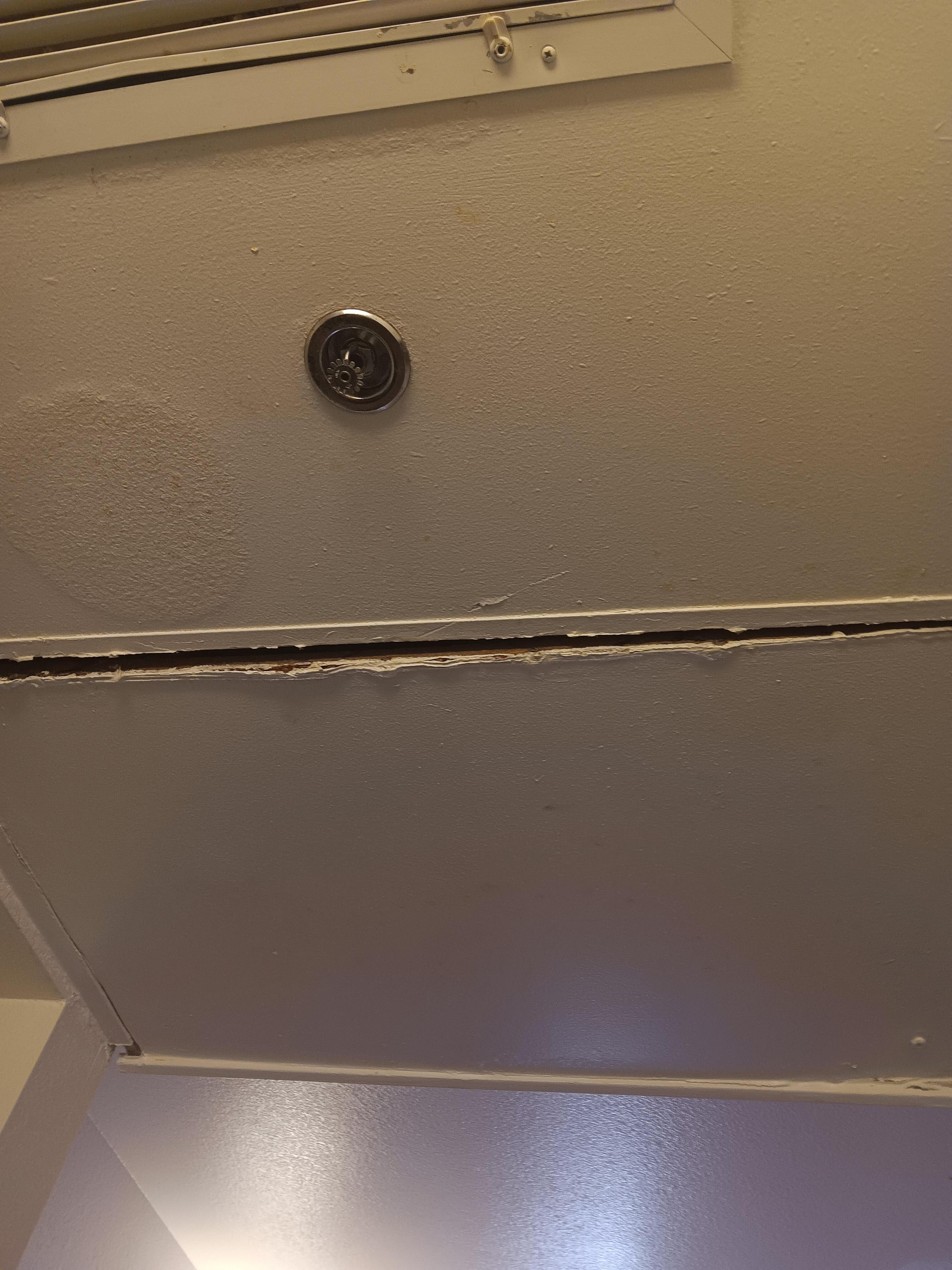 Part of the ceiling by the sink, almost falling down.