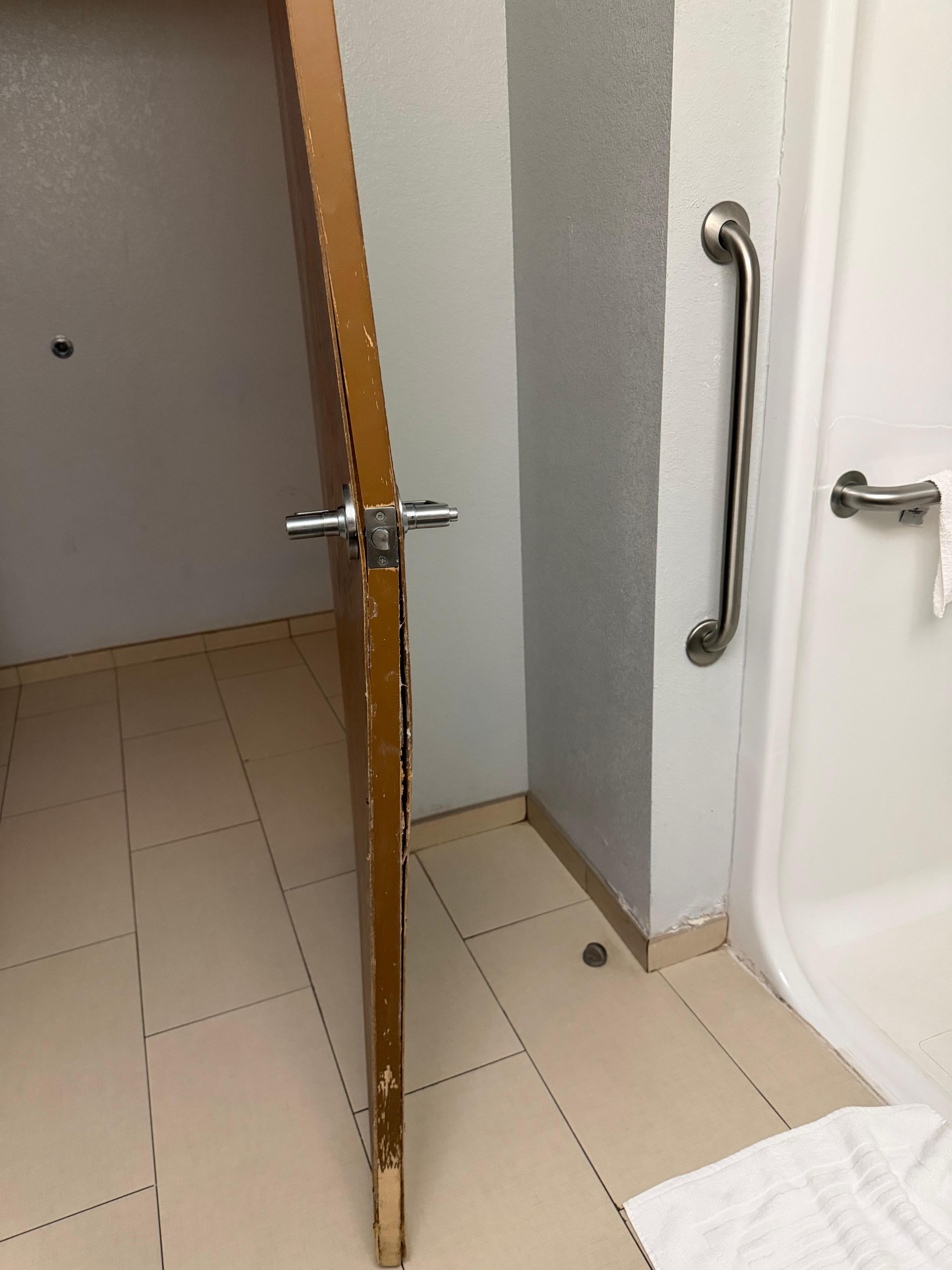 Warped bathroom door preventing it to close. 