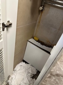 Dirty towels and water damage in the bathroom