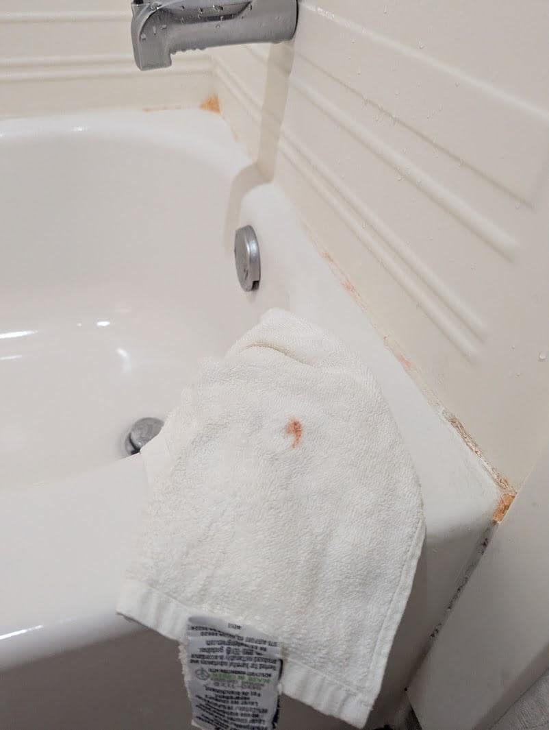 Orange mold on tub.