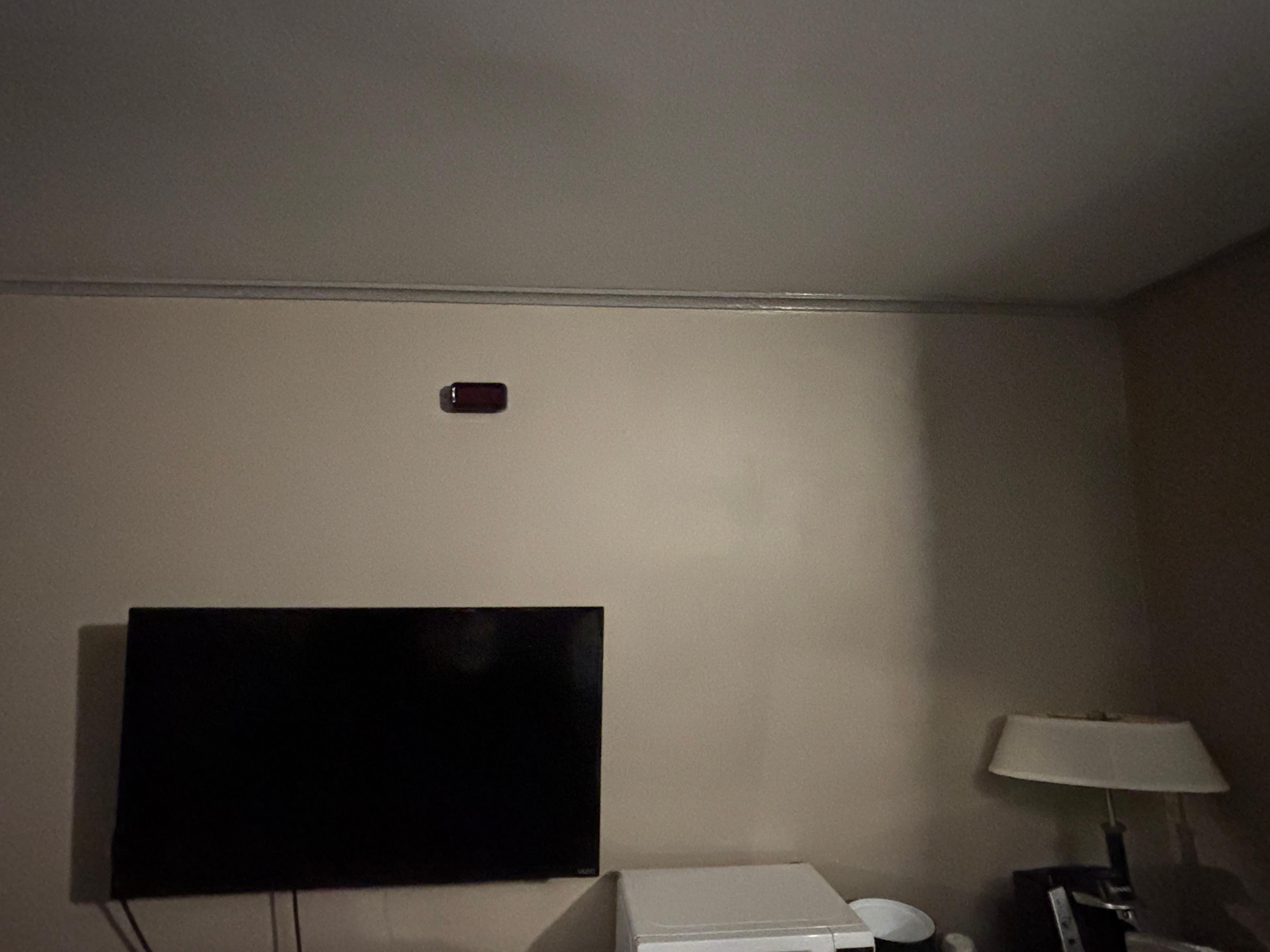 This is the creepy “alarm clock” on the wall that was up by the ceiling that nobody could reach and was not on?