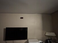 This is the creepy “alarm clock” on the wall that was up by the ceiling that nobody could reach and was not on?