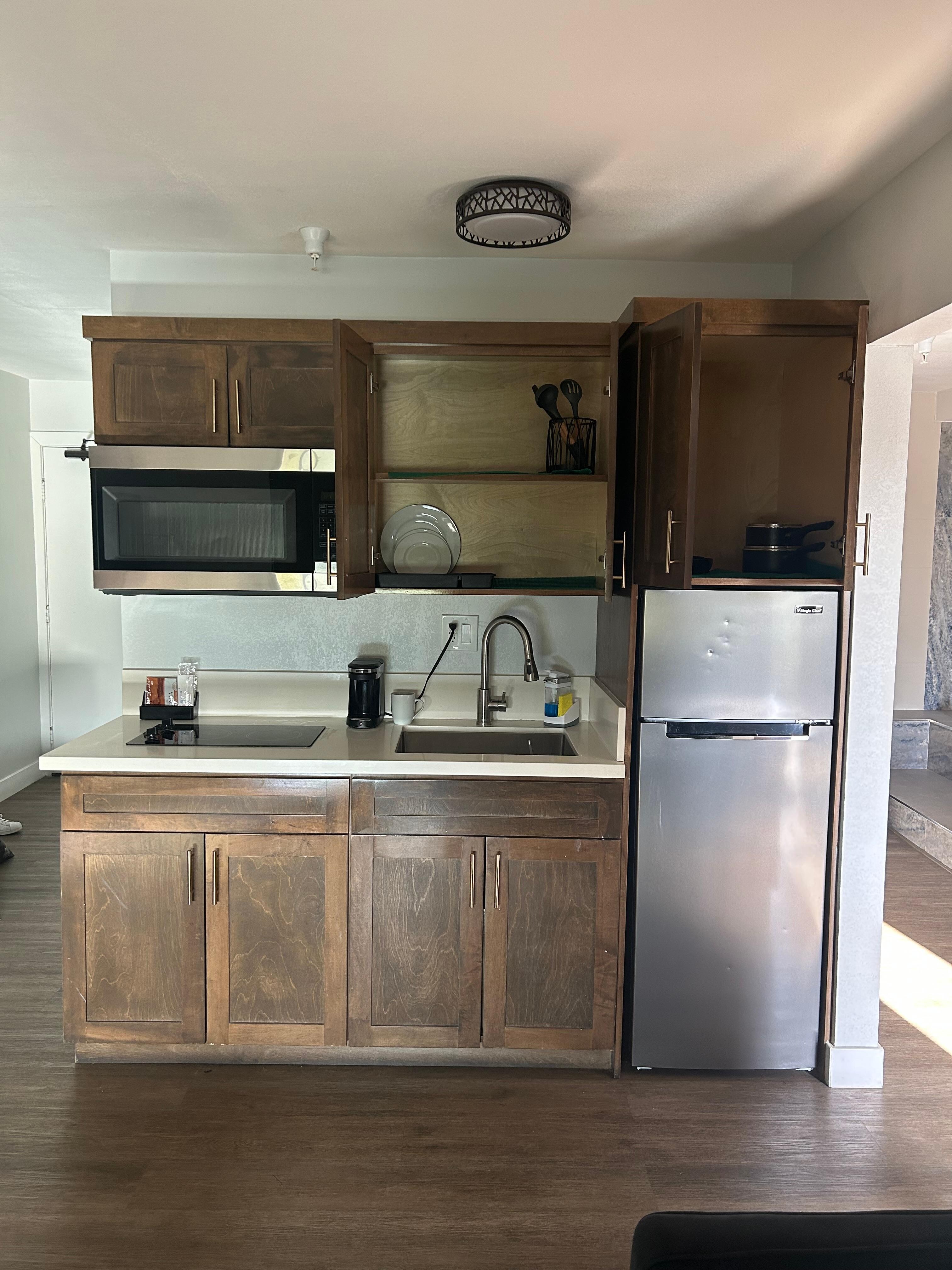 Full kitchen with dishwater and cooking utensils