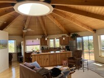 The lovely living room with spacious kitchen, and the cozy reading nook