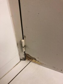 Base of bathroom door worn