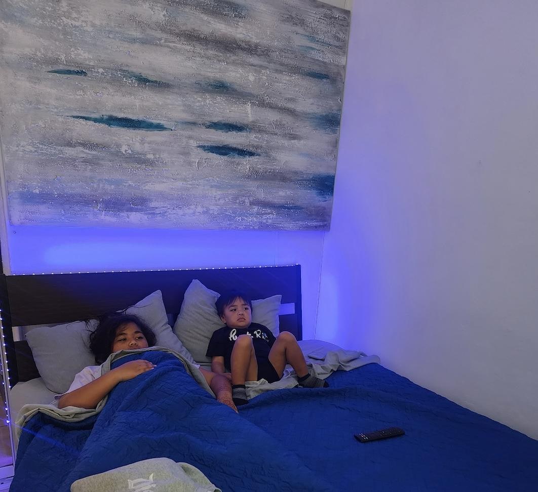 Kids relaxing after taking a shower, watching tv!