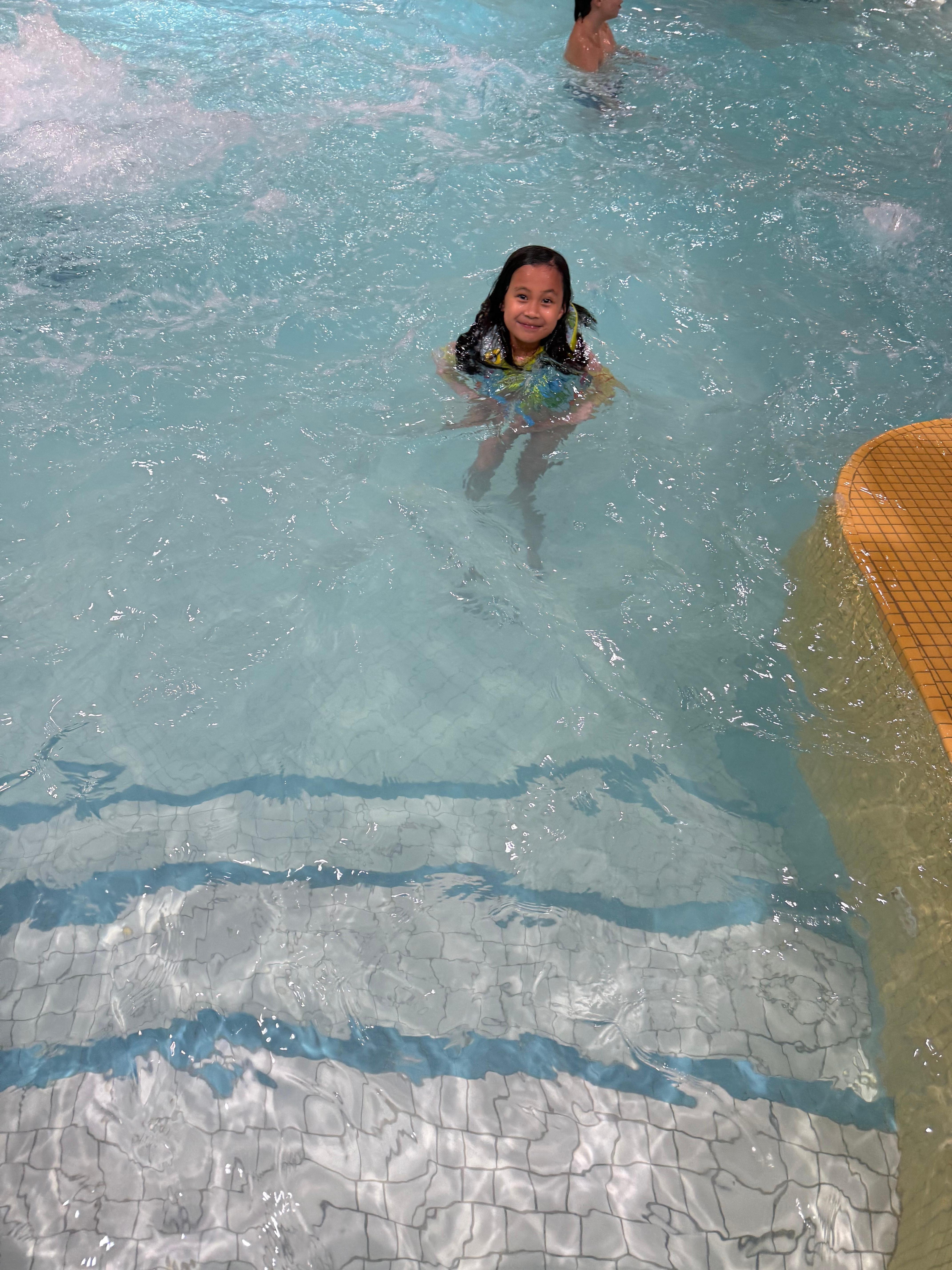 My daughter and her cousin enjoy their swimming.