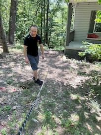 Husband near fire pit and our beagle enjoying himself in nature