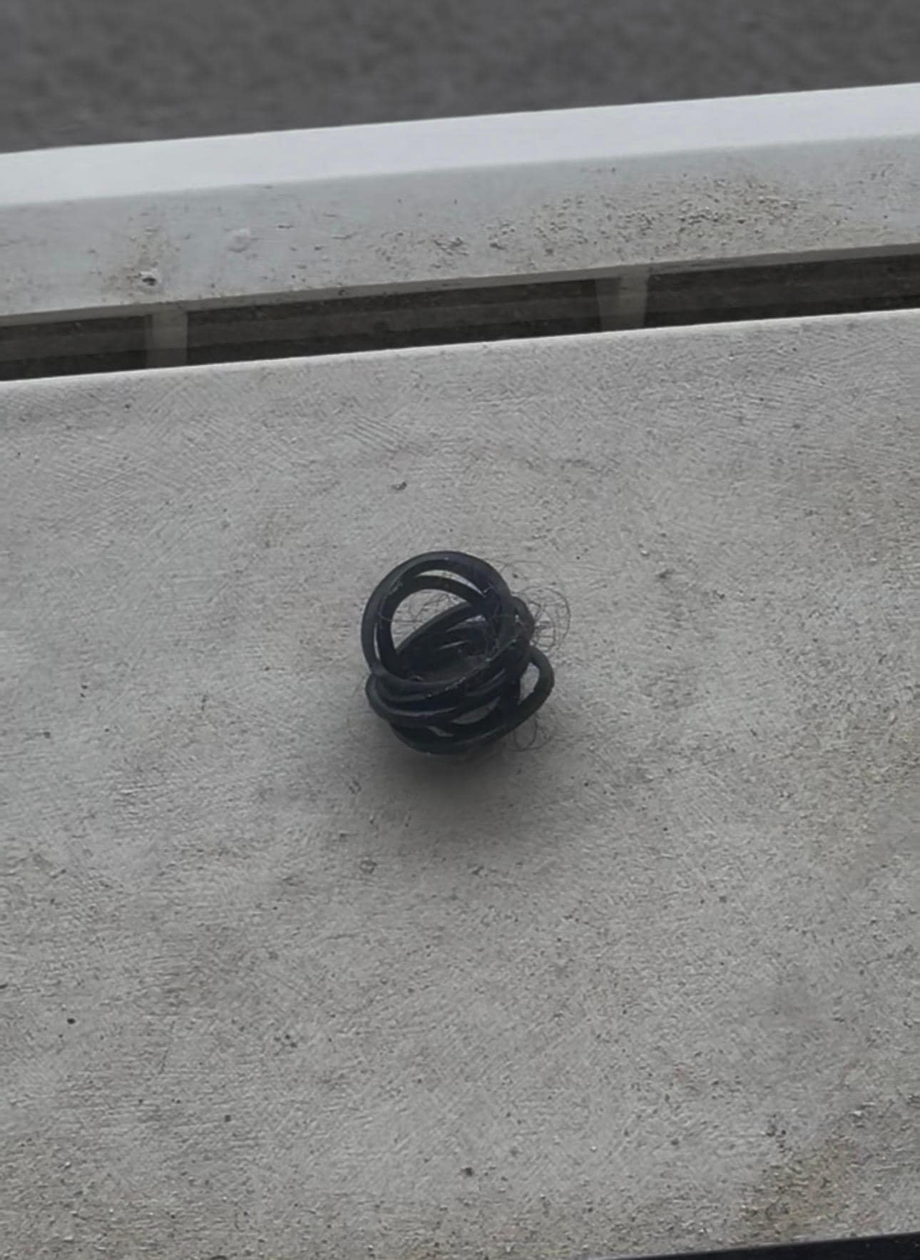 On top on the ac on balcony