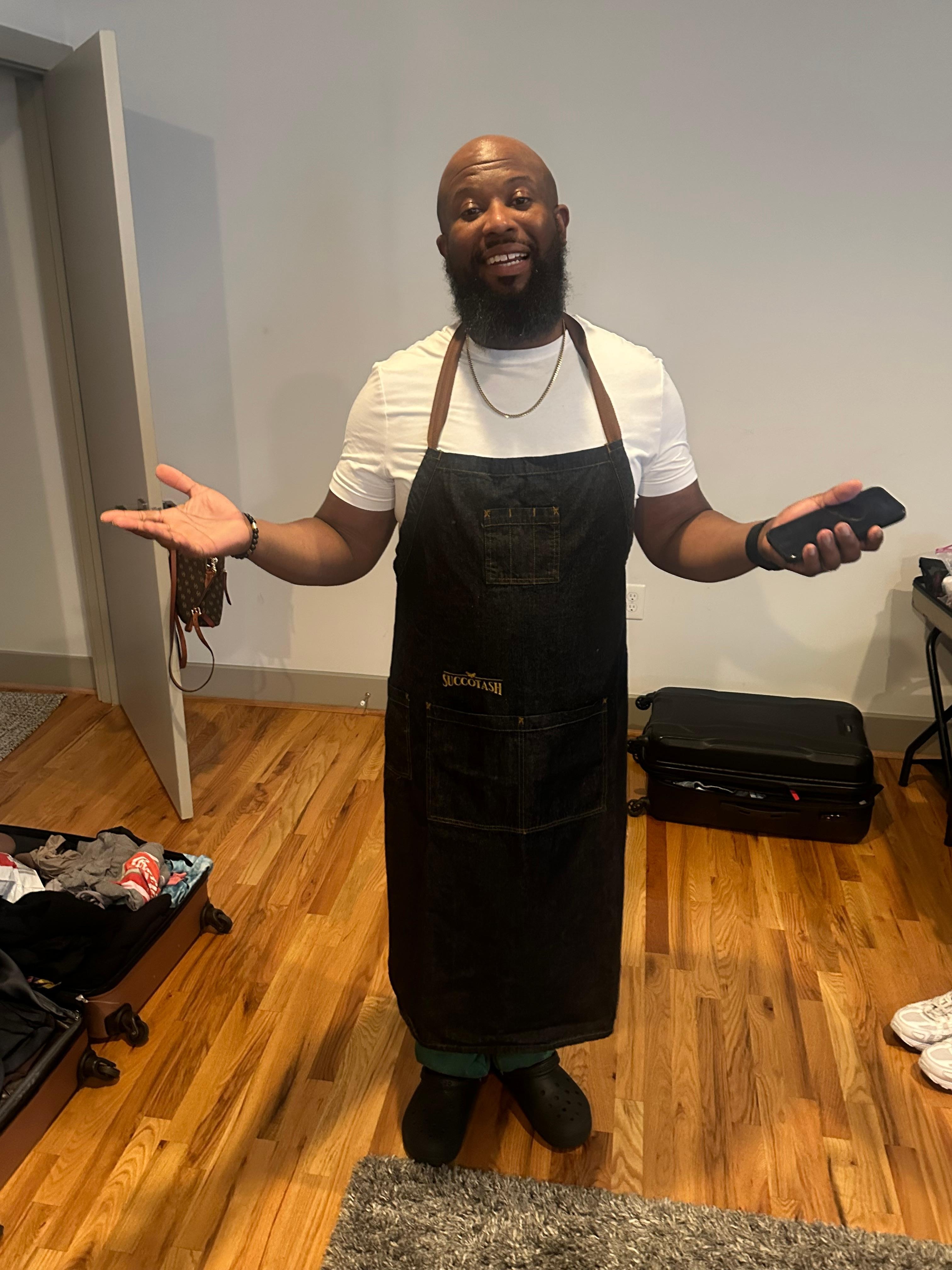 Husband wearing their apron. He found it in the drawer and was so happy he didn’t have to dirty his white shirt. 