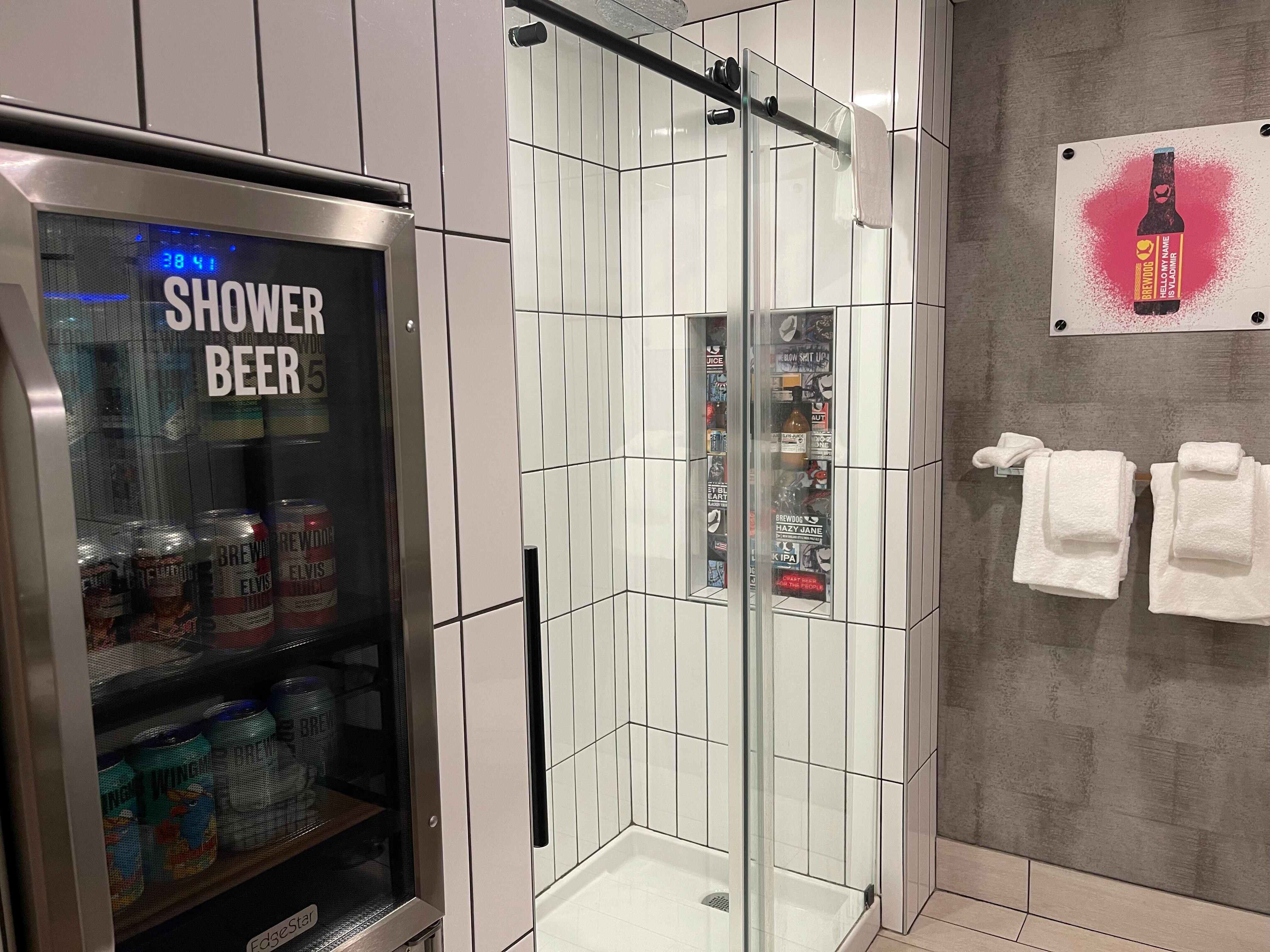 There is a shower beer refrigerator in the bathroom!