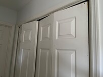 Accordion doors are completely off the track and inoperable in the laundry area.