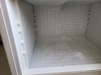 Poor condition of fridge and freezer.