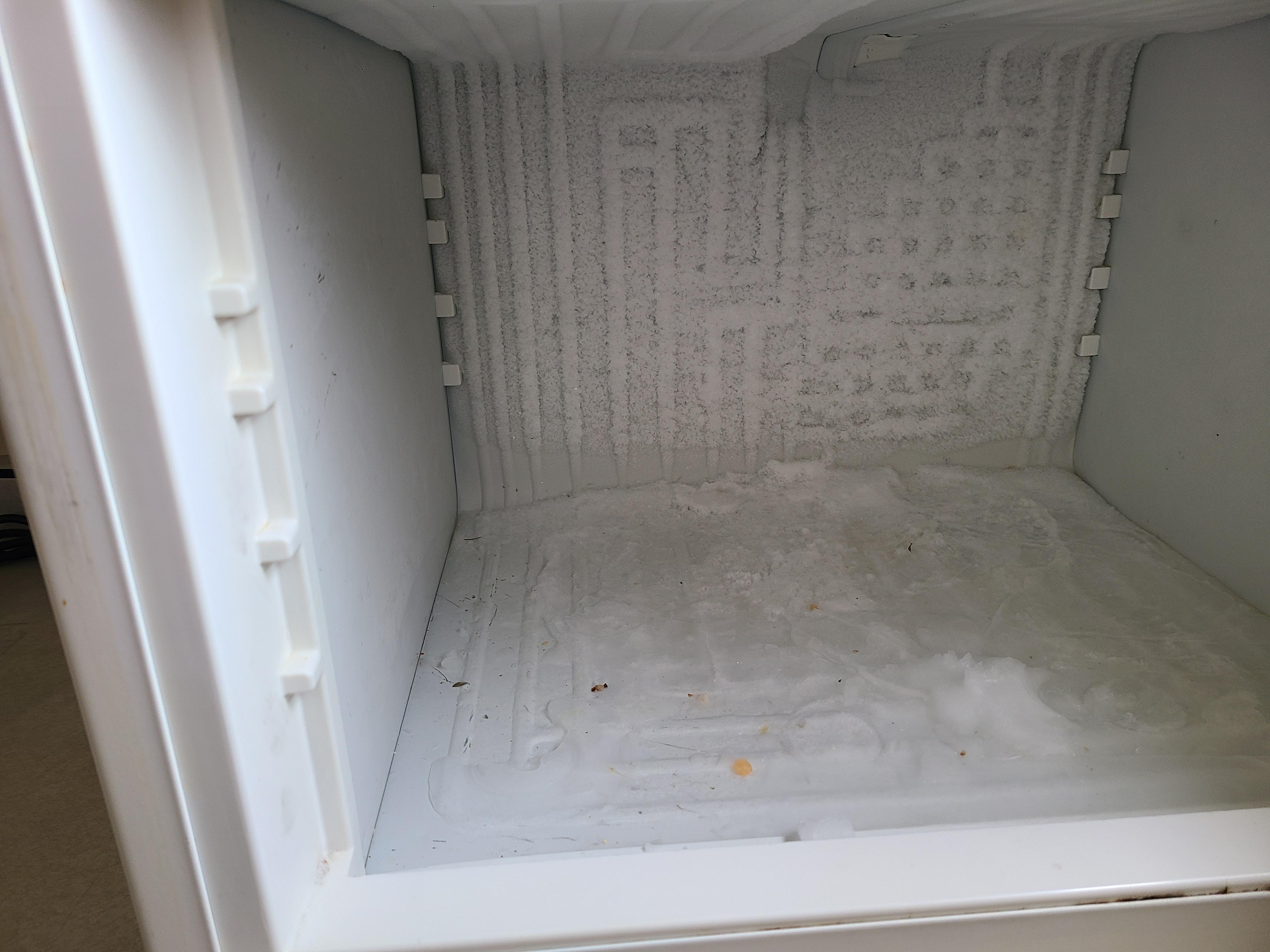 Poor condition of fridge and freezer.