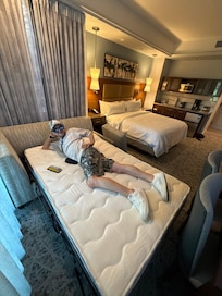 Only one adult can sleep on this pull out bed. It’s in the smaller unit