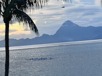 View from our room balcony towards sunset watching longboats glide by