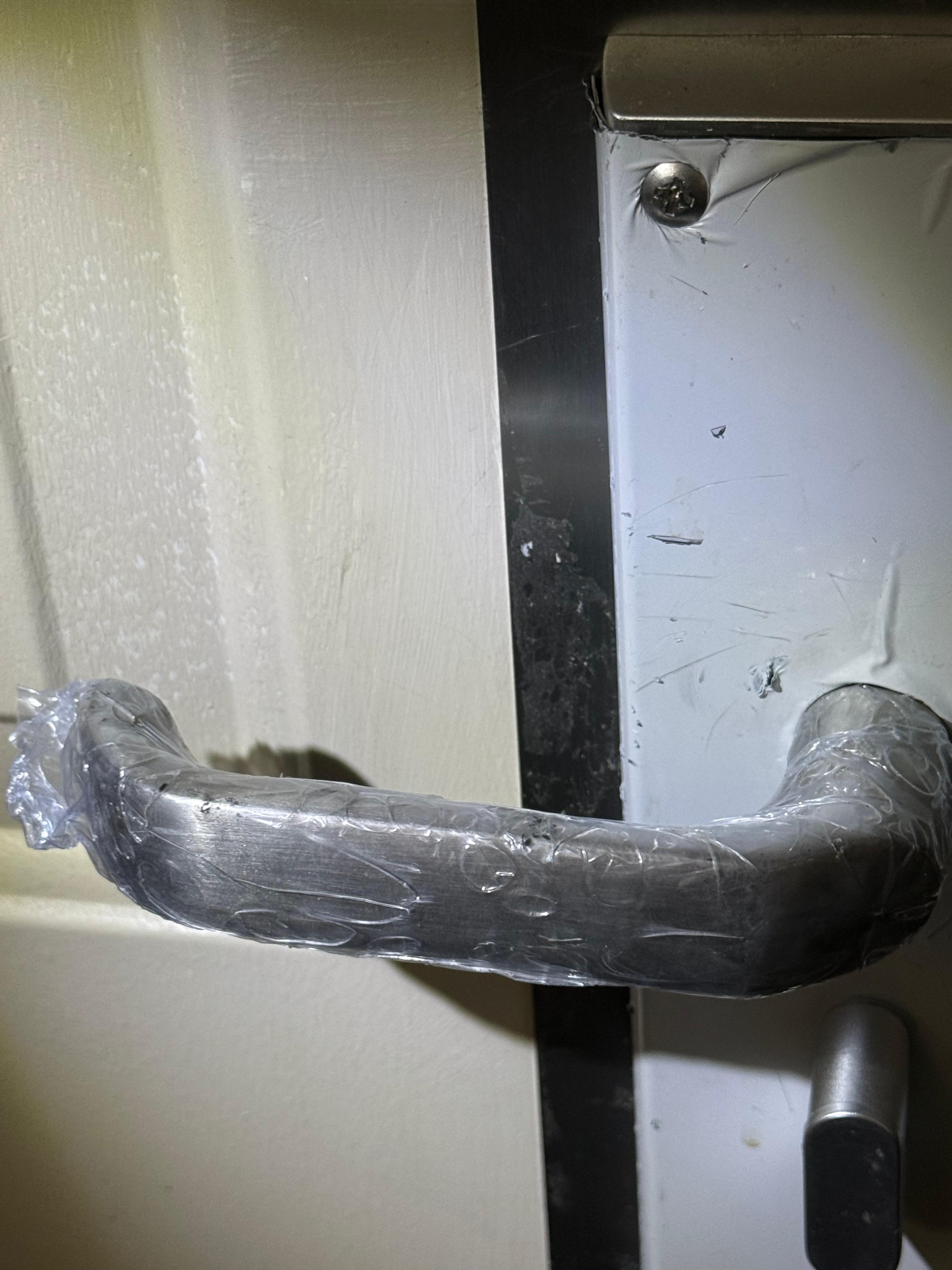 Plastic over door handle inside room