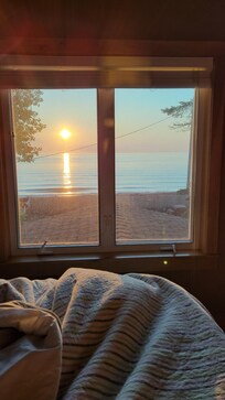 View of the sunrise over the lake from my comfy bed!