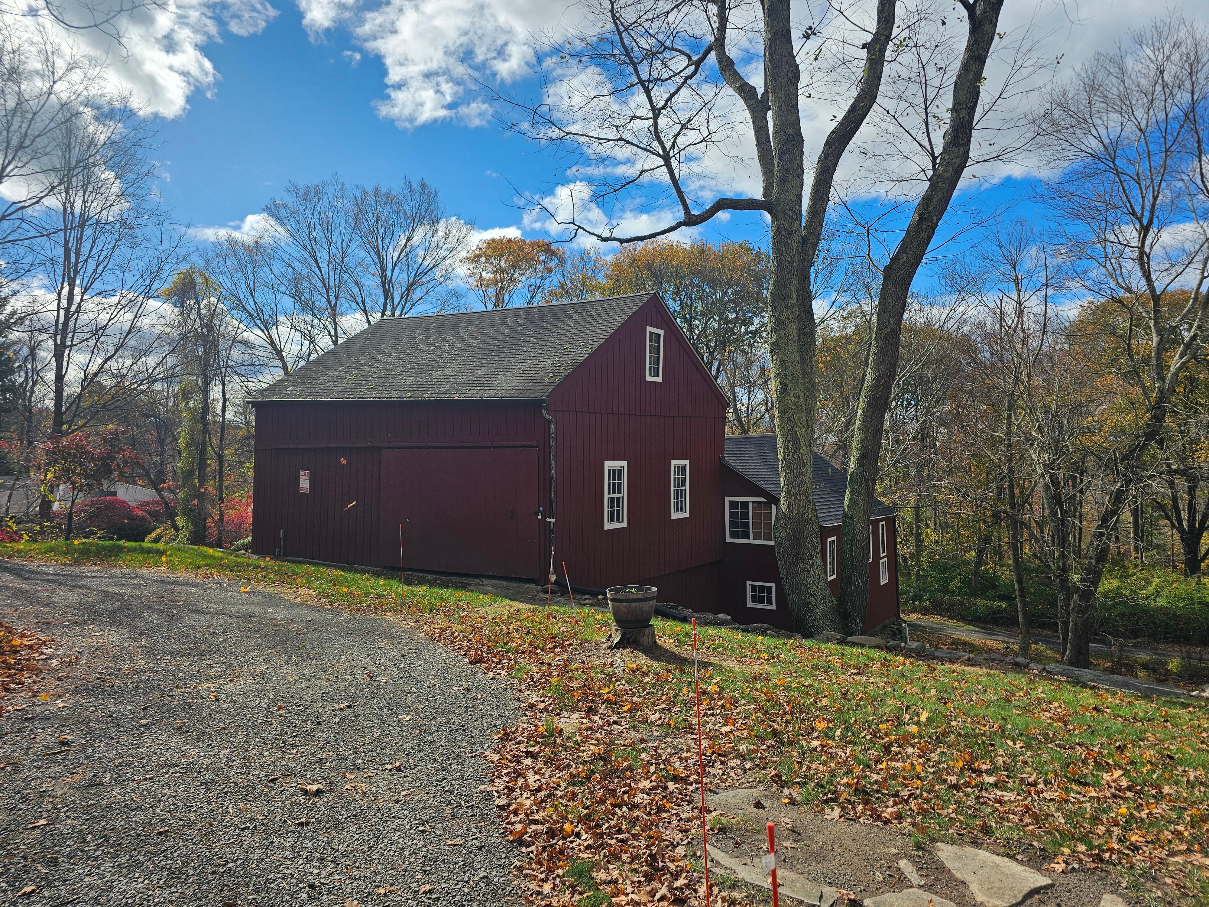 The circular driveway and the barn by the property